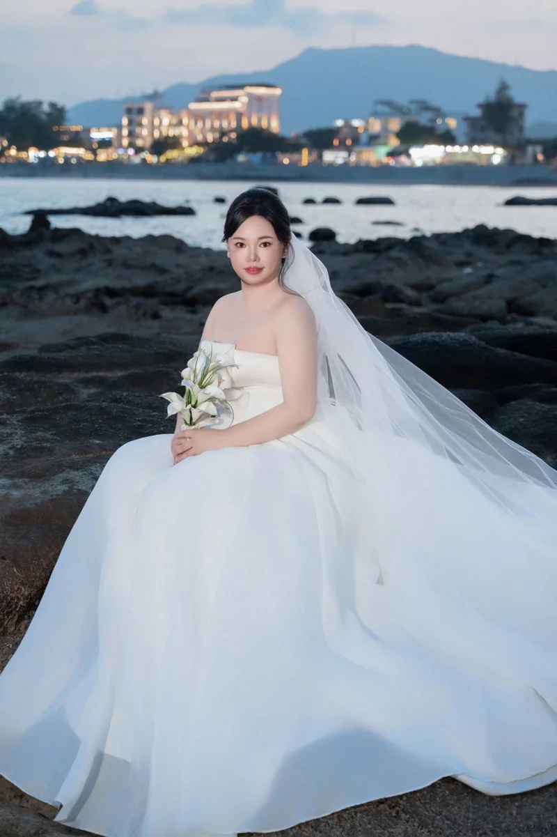 坐在海边礁石上的新娘